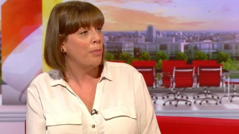 The MP is sat in the BBC Breakfast studio wearing a white shirt with brown hair in a bob style