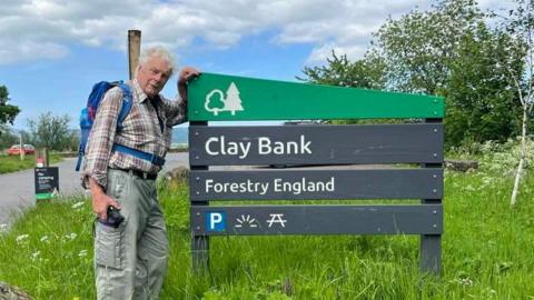 Keith Ogley stands with a sign for Clay Bank in North Yorkshire