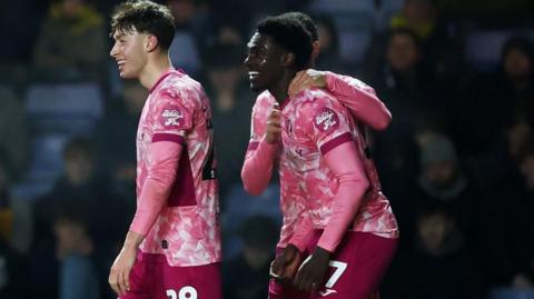 Mohamed Toure celebrates with team-mates after scoring at Oxford