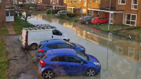 Vehicles parked in flooded street