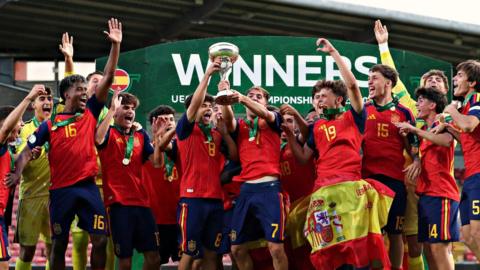 Spain players celebrate with the Uefa Men's Under-19 Championship trophy