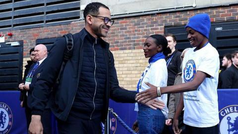 Chelsea manager Liam Rosenoir greeting fans as he arrives at Stamford Bridge