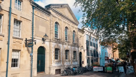 A general view picture of the chapel building and the office building next to it further down the road.