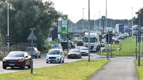 Queues of traffic at the M5 Ashchurch Junction near Tewkesbury with a petrol station in the background.