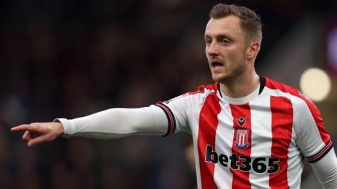 Ben Wilmot points some instructions to team-mates during a Stoke City match.