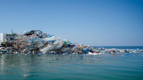 Plastic pollution floating in the sea.