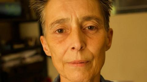 Helen Weston at home looking at the camera.