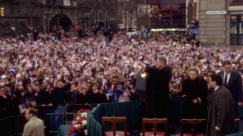 US President Bill Clinton waves to crowds outside of Londonderry's Guildhall.