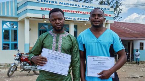  Makati Tagirabo,34, and Baraka Bulambula 29, Congolese health workers who recovered from the Ebola virus hold their certificates of discharge at the Evangelical Medical Center (CEM), as agencies intensify efforts to contain a new Ebola outbreak caused by the Bundibugyo virus strain, in Bunia, Ituri province, Democratic Republic of Congo, May 31, 2026. REUTERS/Gradel Muyisa Mumbere