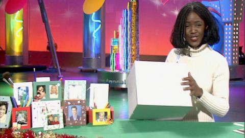 Diane-Louise Jordan holding a box during a demonstration on how to make a photo frame