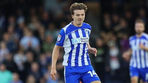 Ryan Treveitt running with the ball at his feet during a match for Wigan