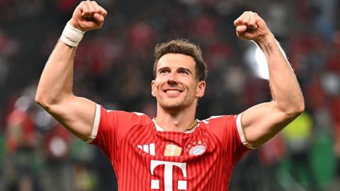Leon Goretzka celebrates Bayern Munich's win the DFB Pokal final by raising both arms above his head