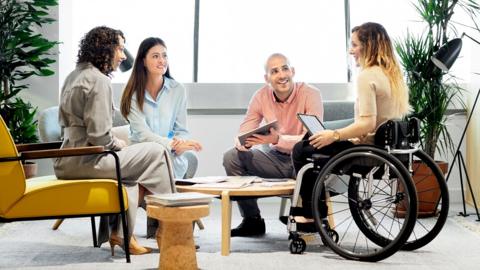 Disabled professional with coworkers in meeting