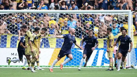Christian Gray celebrates after scoring for Auckland City