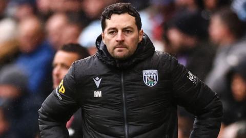 Ryan Mason with his hands on his hips