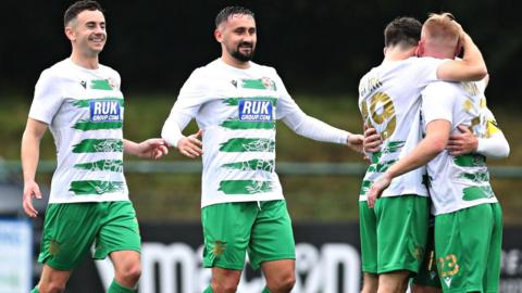 Brad Young celebrates with teammates after scoring  for New Saints