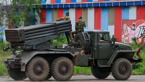 Cambodian soldiers tride a truck equipped with a Russian-made BM-21 rocket launcher in Cambodia's northern Oddar Meanchey province
