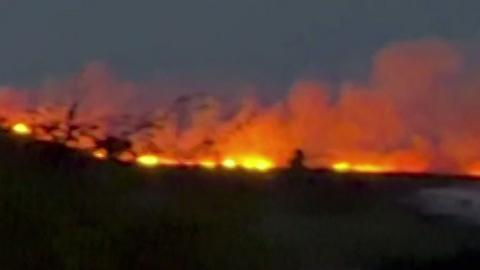 fire with image on the left showing flames on a hill in the dark