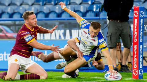 Leeds Rhinos' Ash Handley scores a try in the corner against Huddersfield Giants