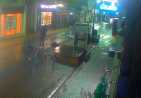 CCTV footage of the two men and the bike after the incident, while the teenager lies on the floor. 