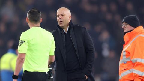 Arne Slot with referee Michael Oliver after Liverpool's draw at Everton