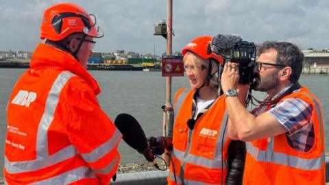 Andrew Harston, chair of East Wind, being interviewed by ý presenter Amelia Reynolds