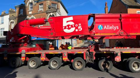 A large red vehicle passing through Ipswich