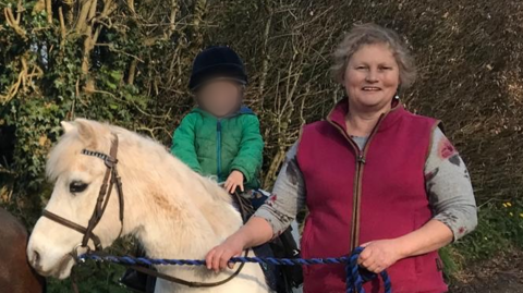 Iris Amelia Wotton with a young rider and her horse