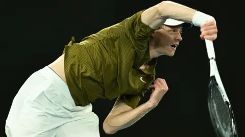 Jannik Sinner hits a backhand