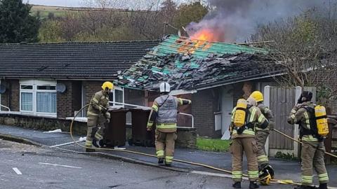 Fire crews at the scene of a gas explosion at a bungalow