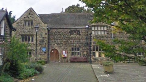 A historic stone building with gabled roofs.