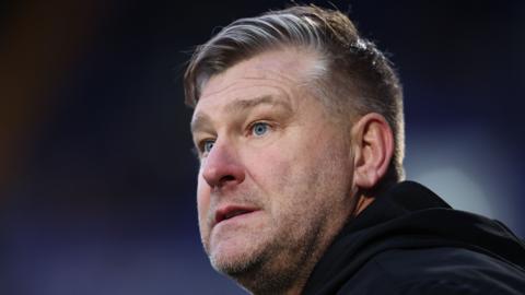 Salford City boss Karl Robinsonb looking pensive