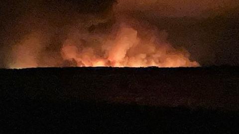 Wildfires visible in the night sky near the coastal town of Lège Cap-Ferret in south-west France