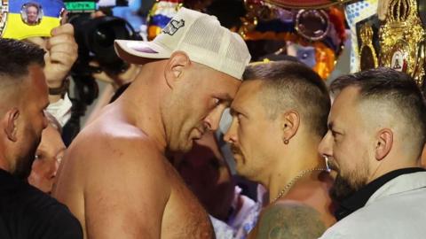 Tyson Fury faces off with Oleksandr Usyk during the weigh-in