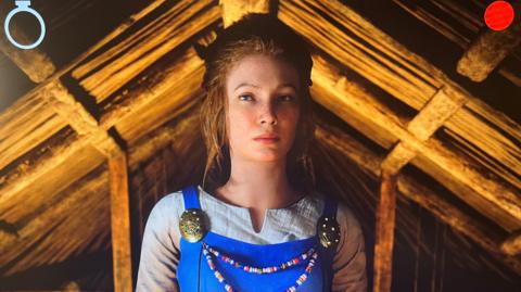 Powered by the insertion of a coin, the AI Viking waits to receive a new token so she can speak again.