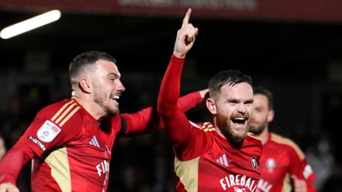 Salford City's Oliver Turton (right) celebrates scoring his side's second goal against Bromley