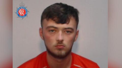 A police mugshot shows Arron Kenny wearing a red Nike top. He has brown hair and a beard and a feint moustache.