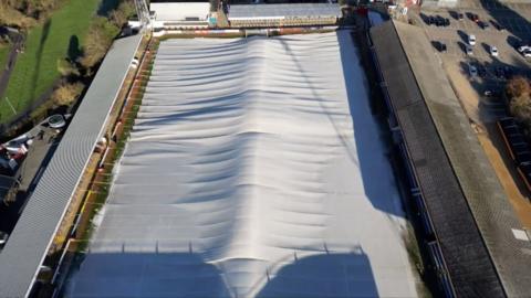 Heated dome covers Cambridge United pitch. Aerial picture.