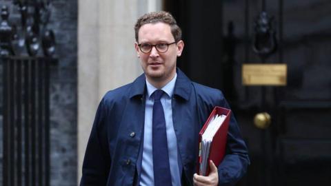 Chief Secretary to the Treasury Darren Jones walking out of Downing Street carrying a red folder