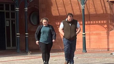 Ellis Judson and Daniel Jones walking with heads down from court building