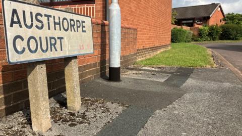 A street sign for Austhorpe Court.