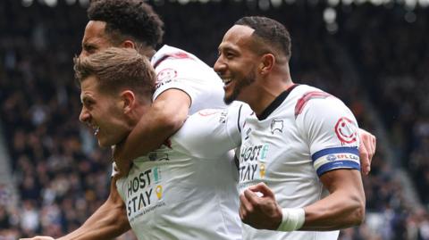 Derby County players celebrate James Collins' goal