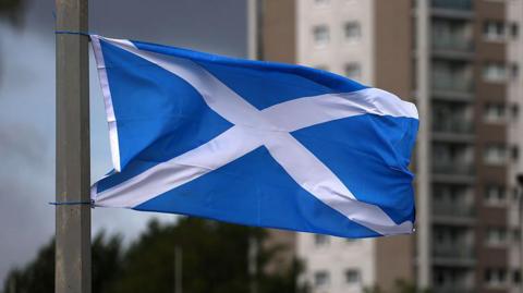 A Saltire flag, flying from a lamppost