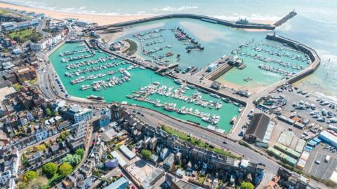 Aerial view showing Ramsgate Royal Harbour, marina, and beach on a sunny day