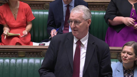 Northern Ireland Secretary of State Hilary Benn standing up in the House of Commons