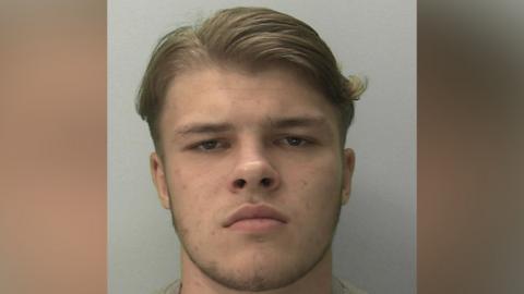 Sonny Boyes looking into the camera. He has brown eyes and hair.