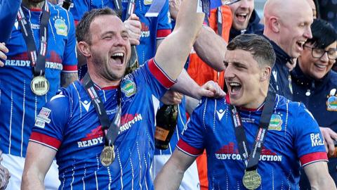 Joel Cooper and Jamie Mulgrew celebrate lifting the GIbson Cup
