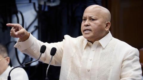 Philippine senator Ronald Bato Dela Rosa speaks from a podium on the Senate floor