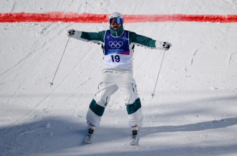 Cooper Woods celebrates on skis