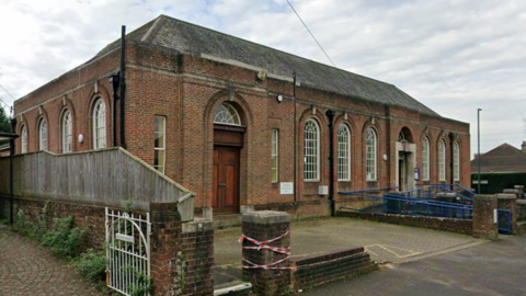 Google Streetview image of a red brick building, which is Charminster Library